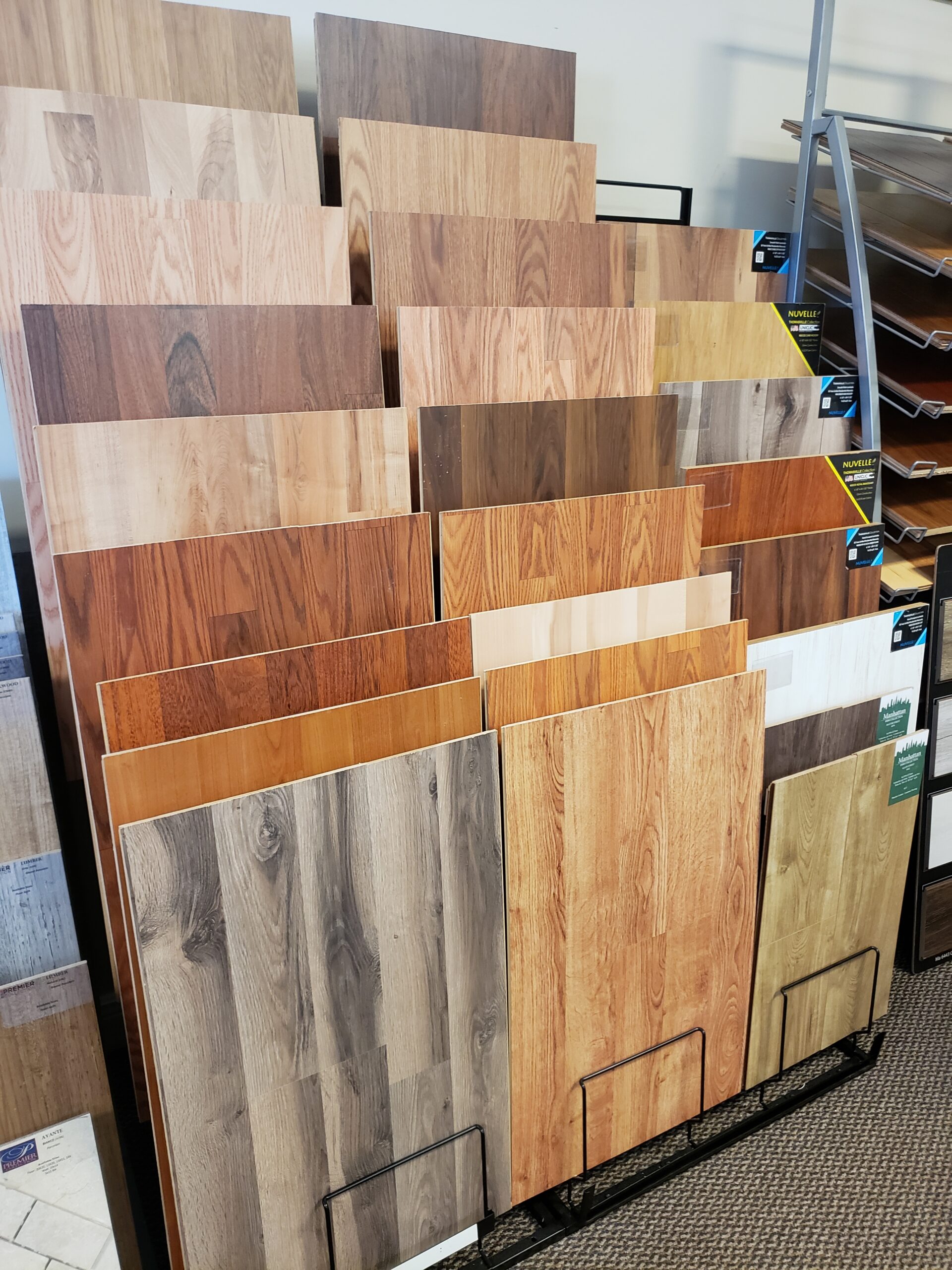 Tricolor Flooring's assortment of floor samples in a rack